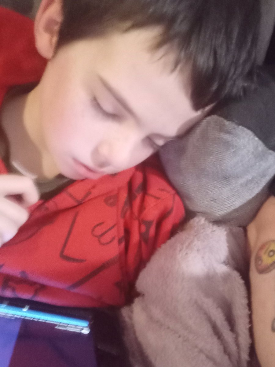 My boy crashing out next to me no well still listening to YouTube on his ipad x