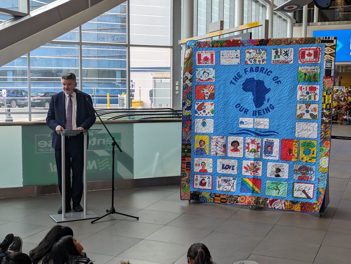 Nieuport's tweet photo. In recognition of #BlackHistoryMonth and #InternationalDecadeforPeopleofAfricanDescent, we were proud to join @PortsToronto, @NadineWilliams, The Honourable @JeanAugustine07,  and nearly 100 grade 4 students from @TDSB_Waterfront earlier today for the unveiling of the Fabric of our Being quilt in our passenger terminal at @bbishopairport.

This art installation was conceptualized by Nadine and her Collective, and features 30 tiles designed by The Waterfront School students, with each honouring a Black Canadian or exploring themes such as recognition, development and justice.

Thank you, Nadine and students, for helping us celebrate diversity, reflect our community and educate everyone passing through Billy Bishop Airport on the significant contributions of Black Canadians! Learn more: https://t.co/d2agcAgYAU

#diversity #DEI #art #YTZarts