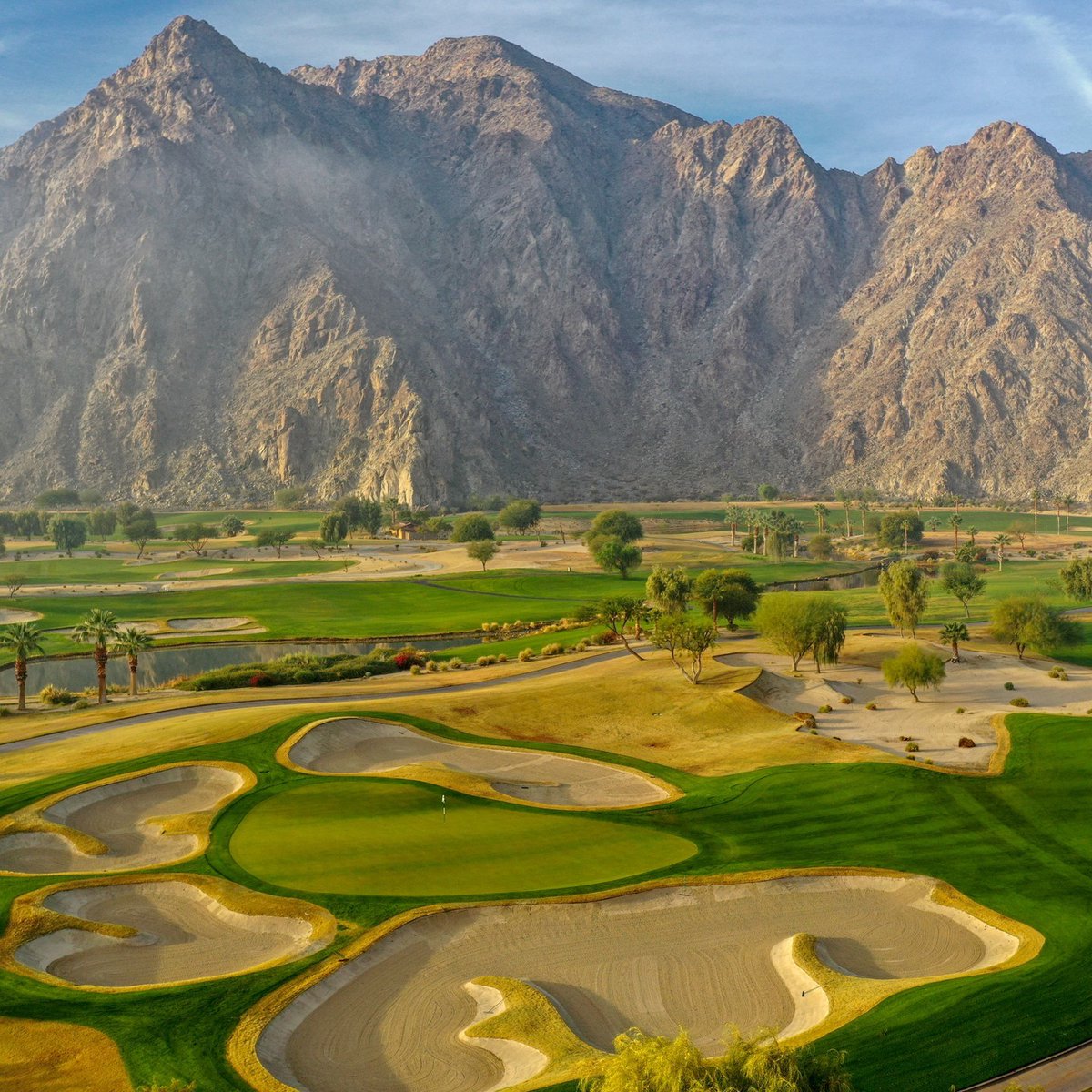 Cheers to winter in Greater Palm Springs, where the sun shines, the pools are blue and the grass is green — vacation bliss year-round. 💫 📸 @CityofLaQuinta