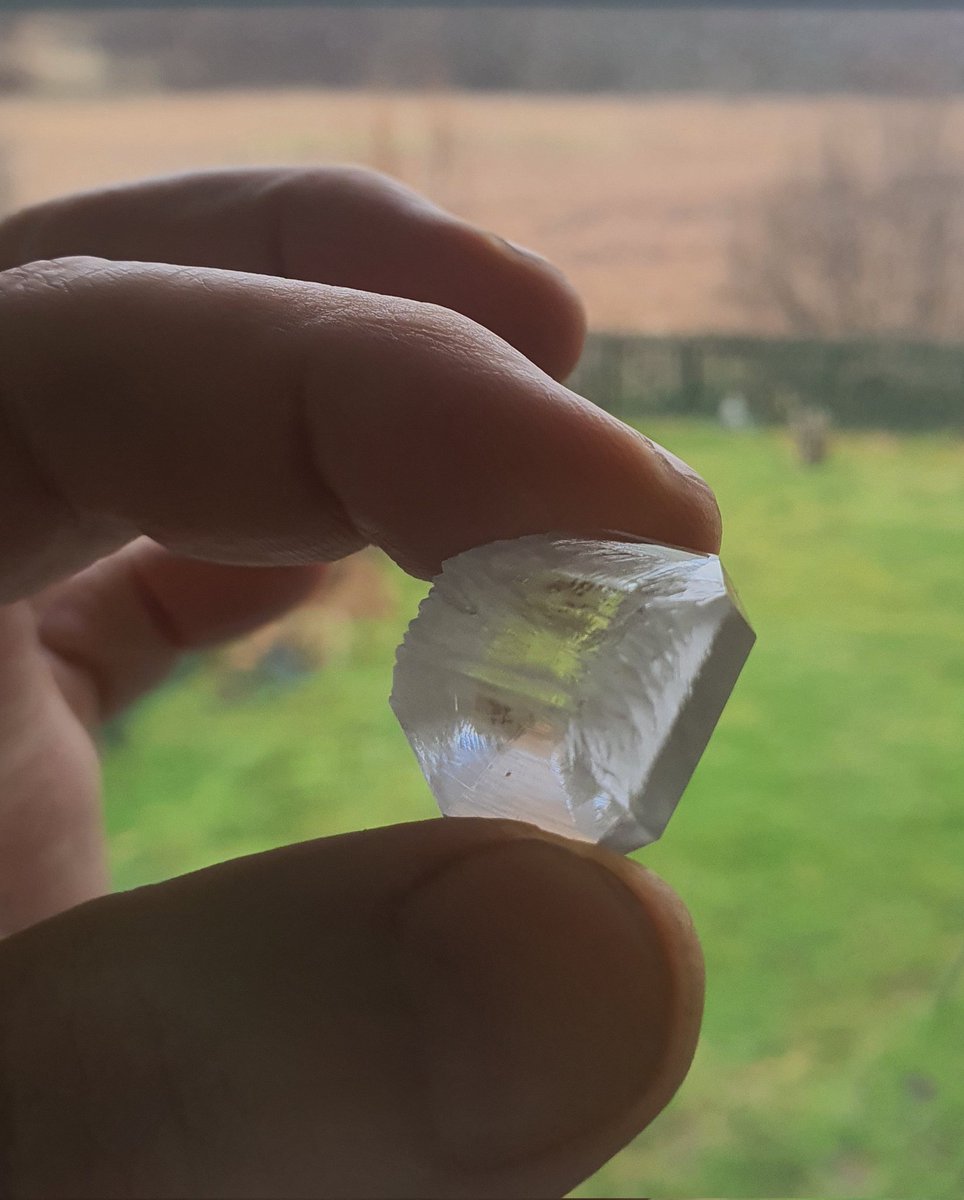 I accidentally grew two large KDP crystals overnight! I was preparing a supersaturated solution for growing.(The other was larger but malformed since it grew against the side of the beaker).
These have a few defects, and aren't quite clear, but still, a nice surprise!