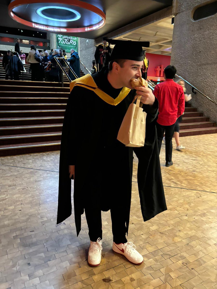 Ikierancarter's tweet image. One more and maybe (final?) graduation post from me. Might have left my life of making croissants behind, but still finding time to stuff my face with one before walking across the stage. Distinction in broadcast journalism MA - completed it.