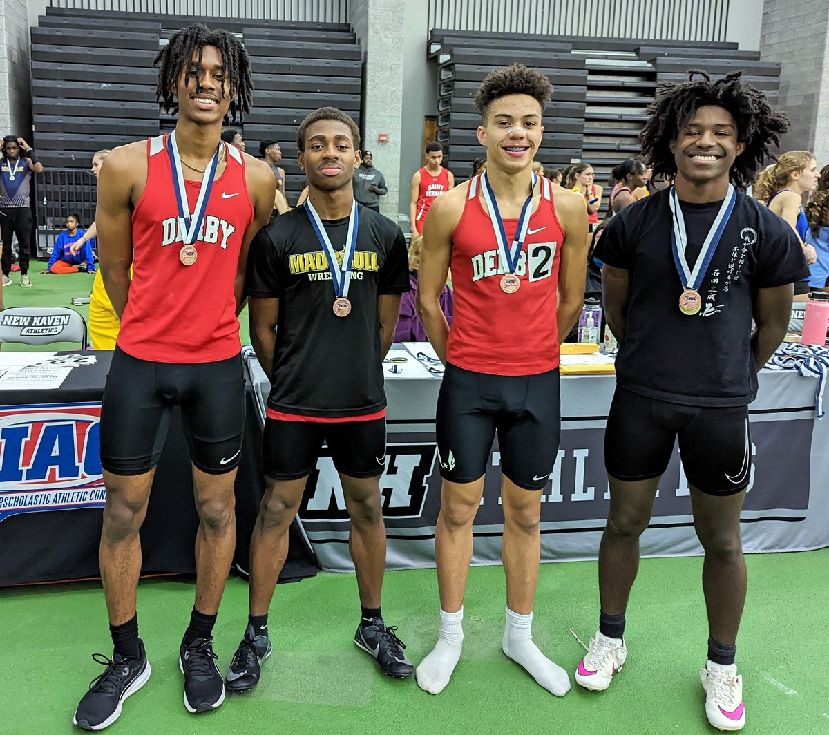 Joel Capelle (3rd from left) displays his medal with Sprint Medley Relay teammates Jaylen Titus, Quincy Carter &amp; Byron McLean after they placed 4th in the Class S Championship. Joel, a freshman who also runs Cross Country for DHS, ran an unofficial 800 meter split in 2:07.6.