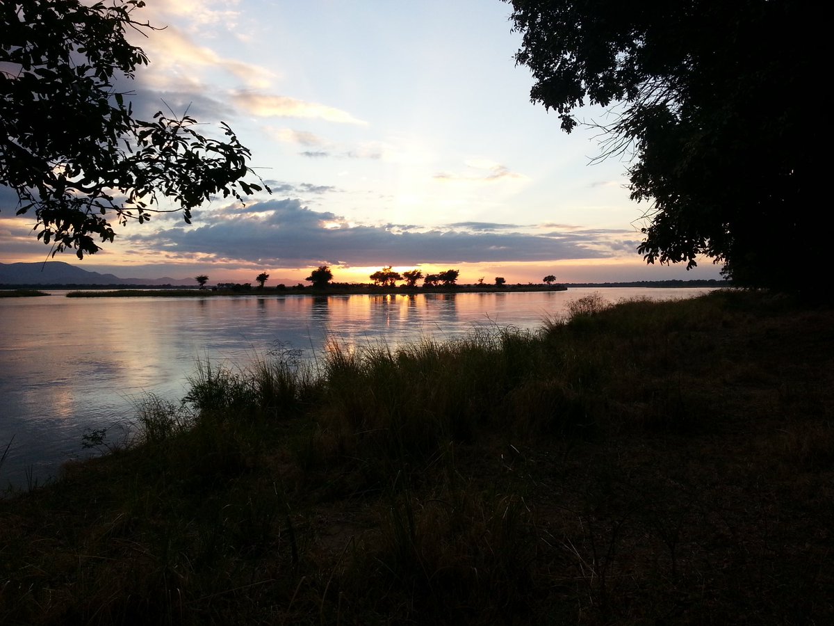 Sunset at Mana Pools after a long game walk. Hippos come out of the water to graze along the banks. Elephants and hyenas visit your campsite in the night and monkeys raid your tents in the morning. Nature at its best. #VisitZimbabwe