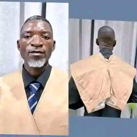 He needed a passport photo to attach to his CV and didn't have a coat, so he had to improvise.Creativity at it's peak.