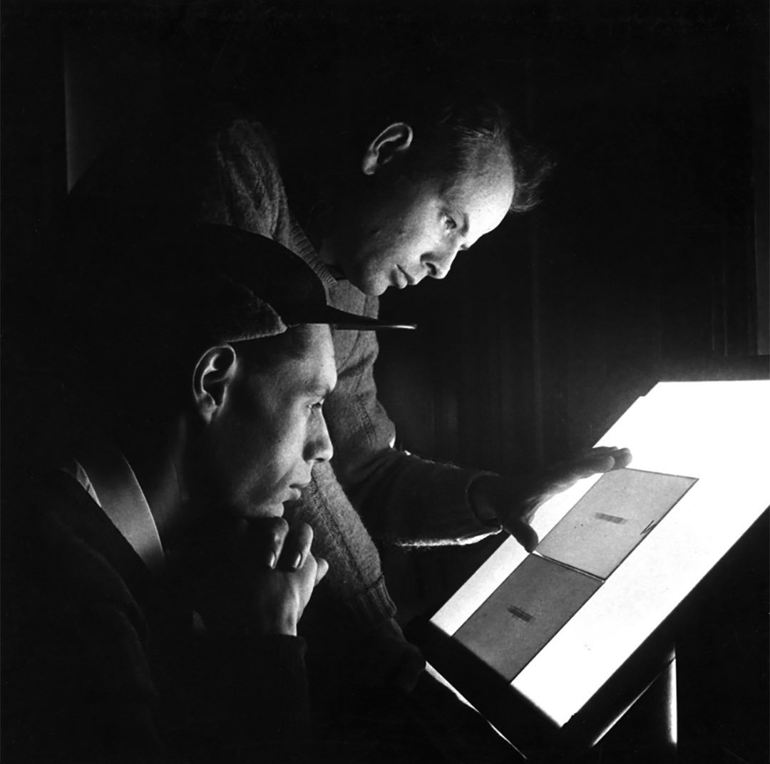 Worthy of an album cover. Yerkes astronomer William Wilson Morgan (standing) and Armin J. Deutsch (seated) are shown here examining astronomical data. They appear to be in deep focus…best not to disturb them. 🤫