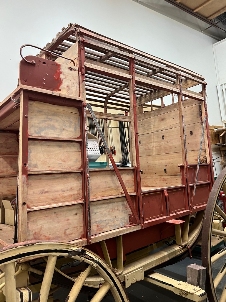 Sanding away history! Prepping the Fort Larned red mud wagon for priming. 🛠️ Did you know? Mud wagons were vital in the 19th century, transporting goods and people across rugged terrains. What animal was commonly used to pull these wagons? #HistoricalTreasure #FortLarned