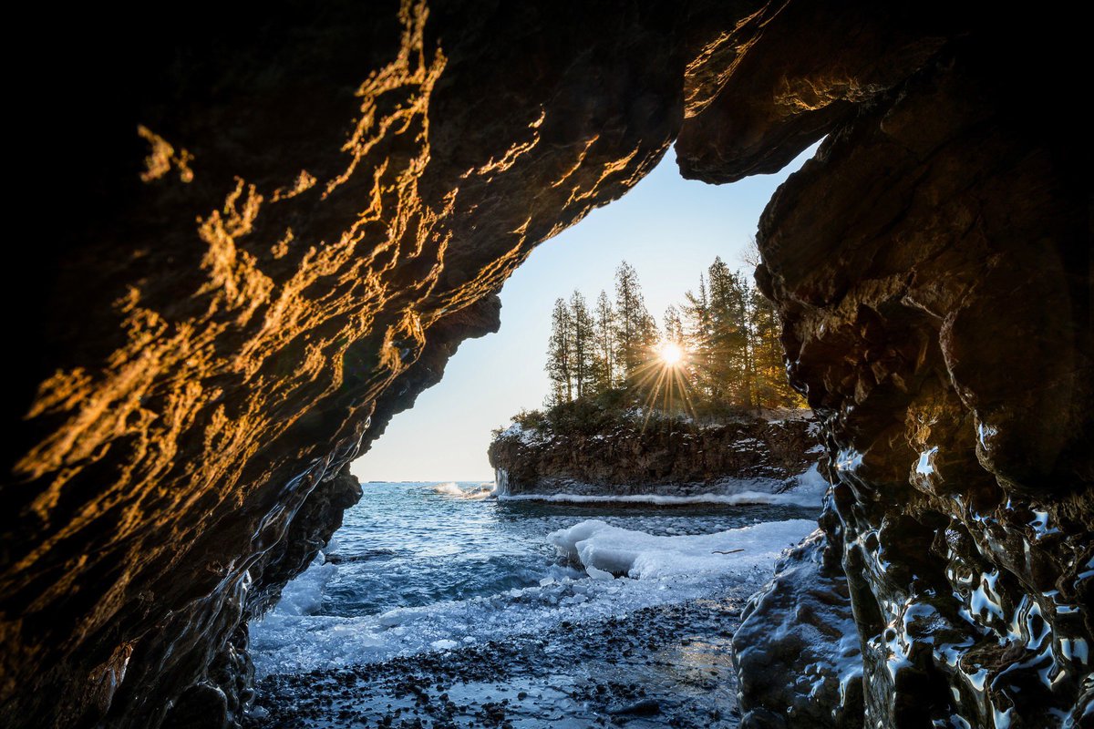 Winter sunrise from a small cave at the edge of Lake Superior. - Marquette County.   #PureMichigan