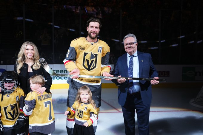 Alex Pietrangelo holds a golden hockey stick with Kelly McCrimmon 