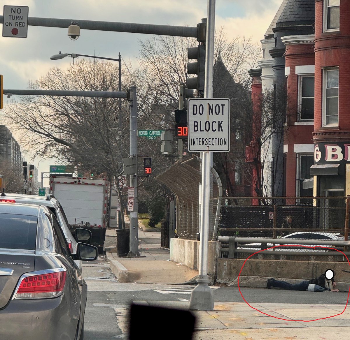 alanhenney's tweet photo. SHOOTOUT ON NORTH CAPITOL ST--- at New York Ave. Two guys reportedly stepped out of an auto and opened fire. Police have found ~36 shell casings so far. 

People dove for cover (see photo).

Amazingly, nobody found shot, yet, but there is damage to a residence on N St NW. #TruxtonCircleDC #NoMaDC #SursumCordaDC @nigro4dc #DCTraffic #DCCrime