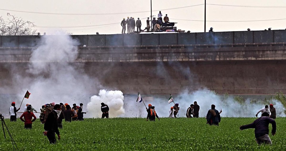 Police personnel fire pellet and tear gas on Protesting Farmers ahead of their "Delhi March" at Shambhu barrier in Punjab