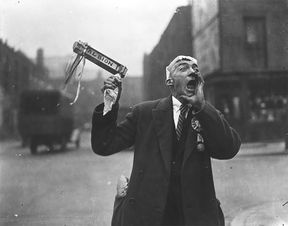 YesterdayLondon's tweet photo. A West Brom fan waves his rattle and cheers as he makes his way to Wembley Stadium for the FA Cup final between West Brom and Sheffield Wednesday. Wednesday won the match 4-2 - 27th April 1935 https://t.co/5S2Q2hgHzy