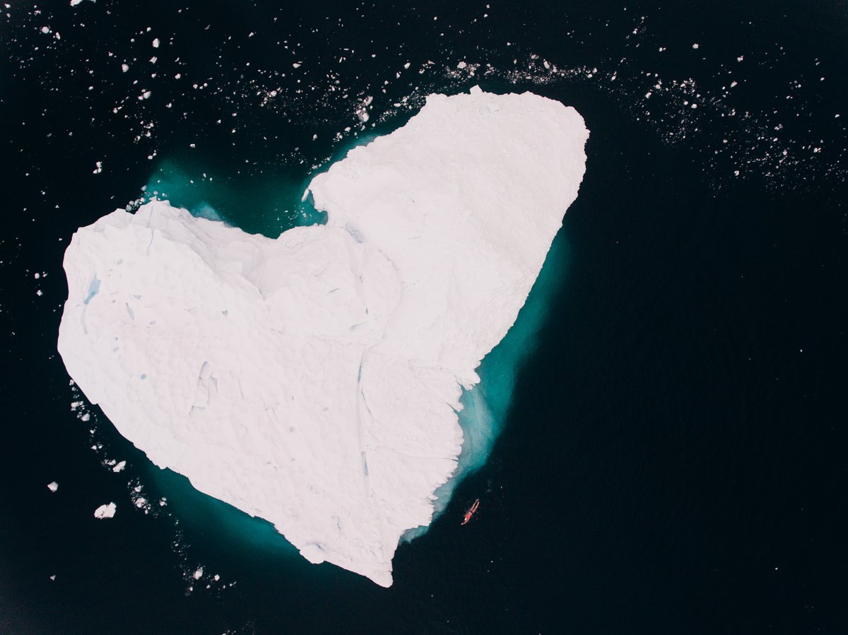 My love for Antarctica summed up in one photo. Can you spot me swimming around this heart-shaped iceberg? 🏊‍♂️🔎💙 #ValentinesDay