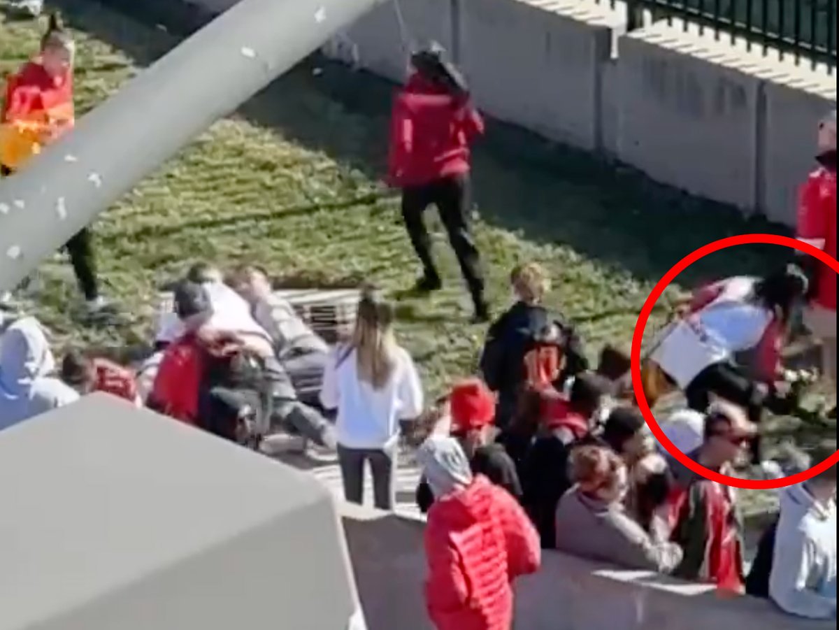 lancepufahl's tweet photo. You can see this lady picking up and moving the automatic rifle that fell from the suspect's coat when the men tackled him (and while he's still on the ground).  All of these Chiefs fans are heroes. https://t.co/ijB67CmJNZ