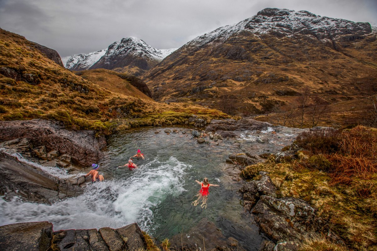 Wild swimmers brave the icy clear water at the Meeting of Three Waters near Glencoe in the Scottish Highlands. @SWNS