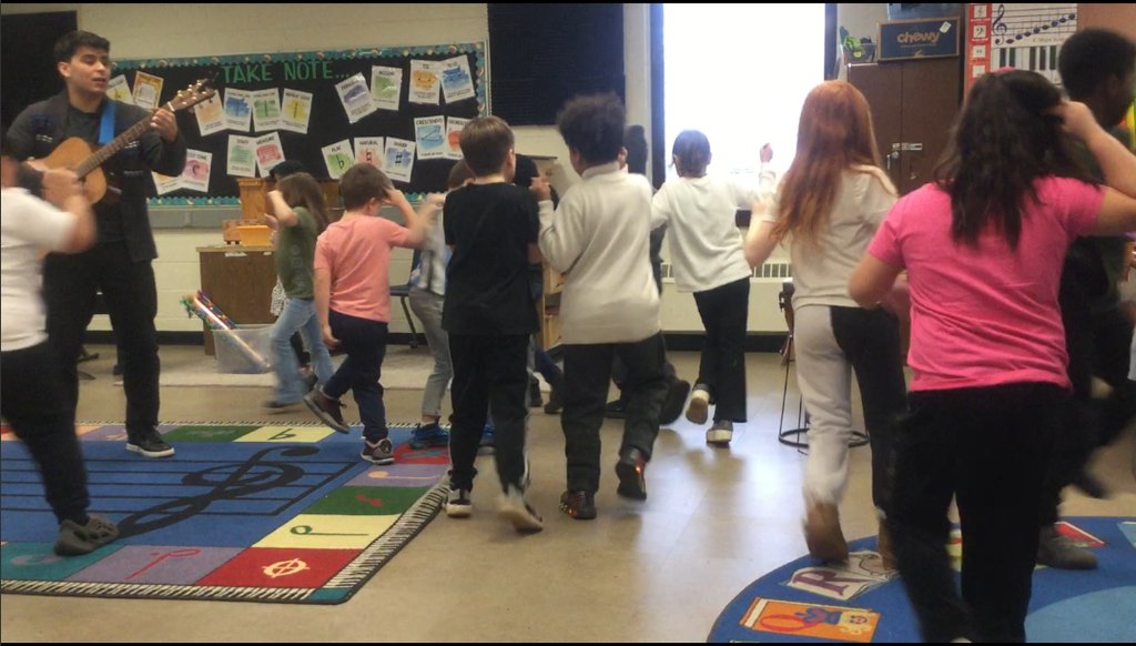 2nd Grade has been testing their ability to multitask this week by walking, fanning, cutting, and hula hooping while singing 'My Aunt Came Back' with Mr. Mitchell in Music class.