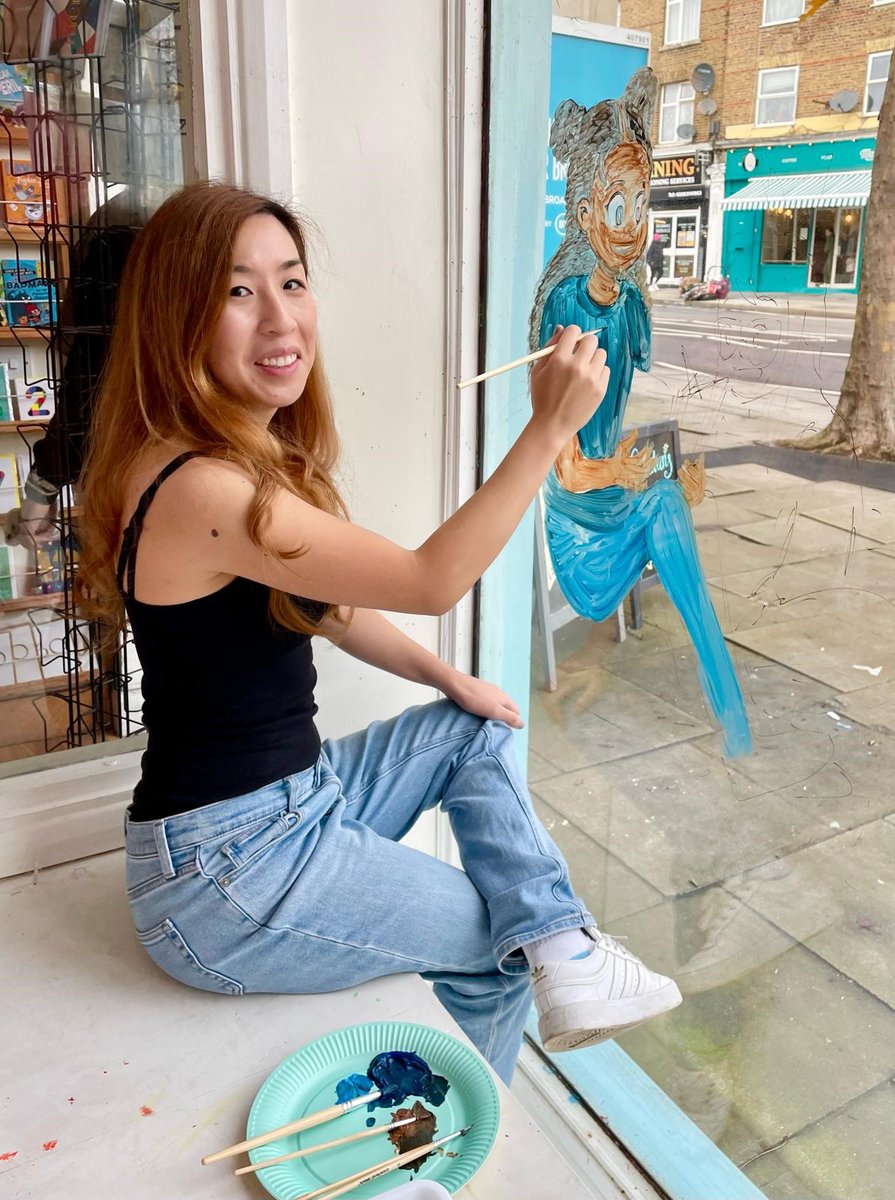 To celebrate the first day £1/€1.50 tokens can be swapped for the brilliant World Book Day books for free, we're at @moonlaneink with our 2024 illustrator Vivian Truong @SuperRisu, busy painting one of our characters on the window!
