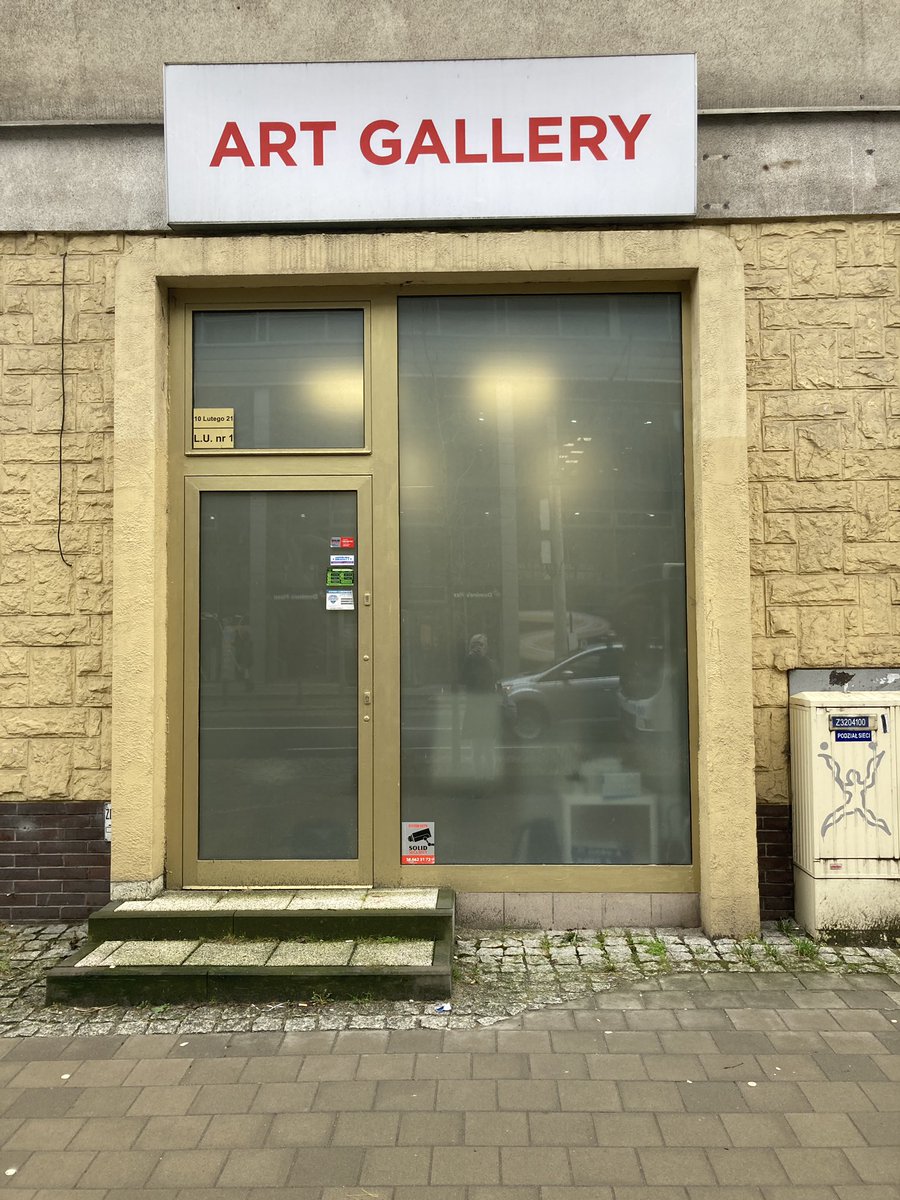 reverend_5's tweet image. This nondescript „art gallery” has been in Gdynia for over a year. It has never opened, there’s no doorknob, but the lights are on every day and quite often there’s people inside. Give me your best guess as to what this place is
