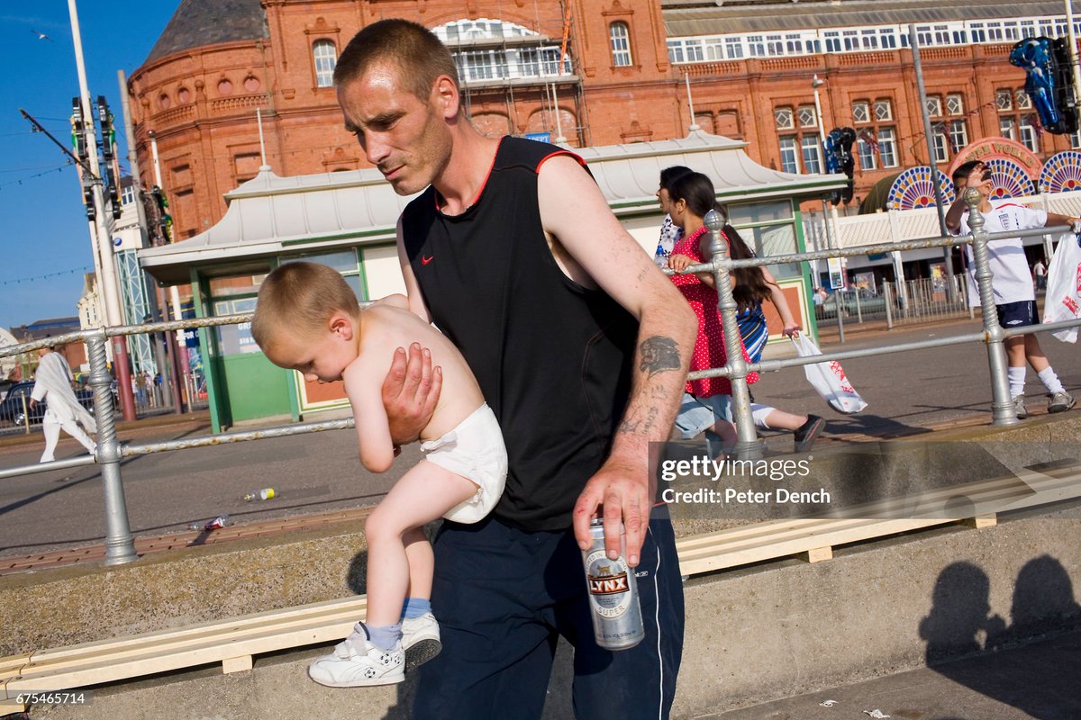 A father with his young son and a can of lager by the benches on Blackpool promenade (2008)