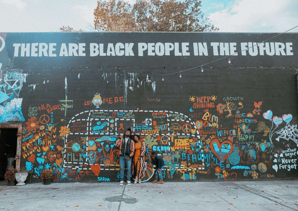 This photograph by Marley Nichelle shows a family by a Charlottesville mural. The artwork is meant to show the resilience of Charlottesville’s Black community. Learn more here: loom.ly/4pdbnig #BlackHistoryMonth #Virginia #history #Charlottesville #BlackArt