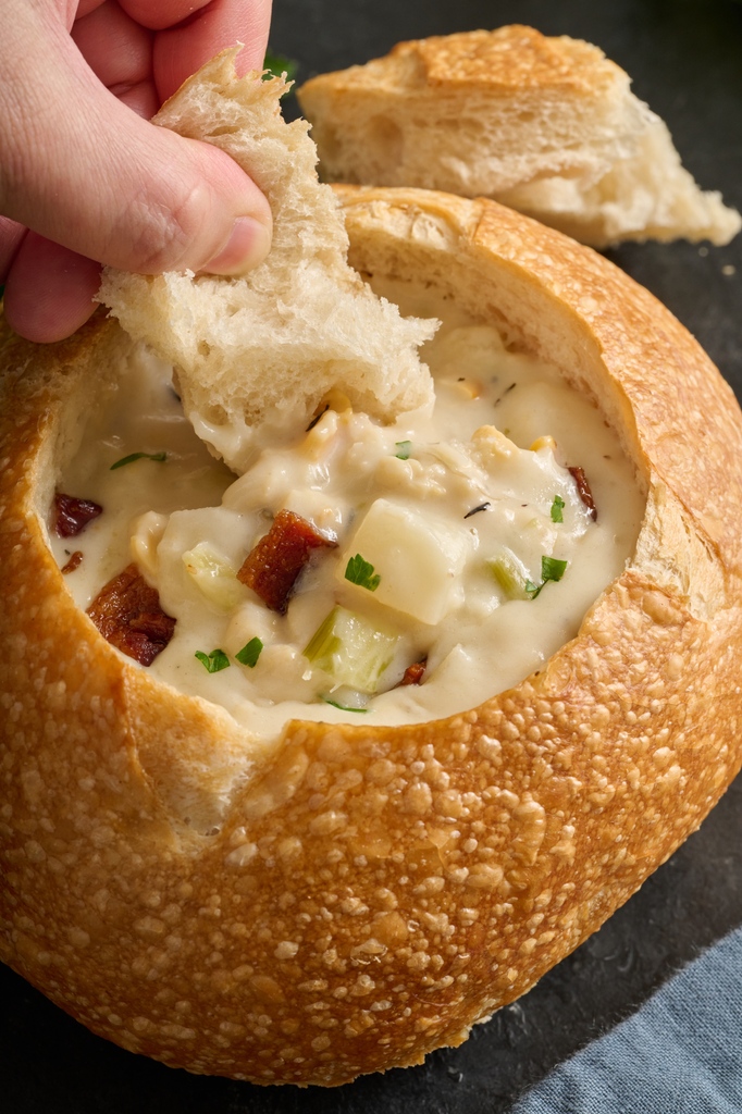 Our irresistible New England Clam Chowder is back! Make this soup tastier by ordering it in a freshly baked sourdough bread bowl. 🤤 #PortosBakery #Portos #Soup #Seasonal #ClamChowder