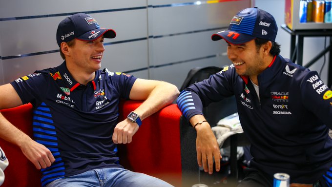 Max Verstappen and Checo Perez sit together.
