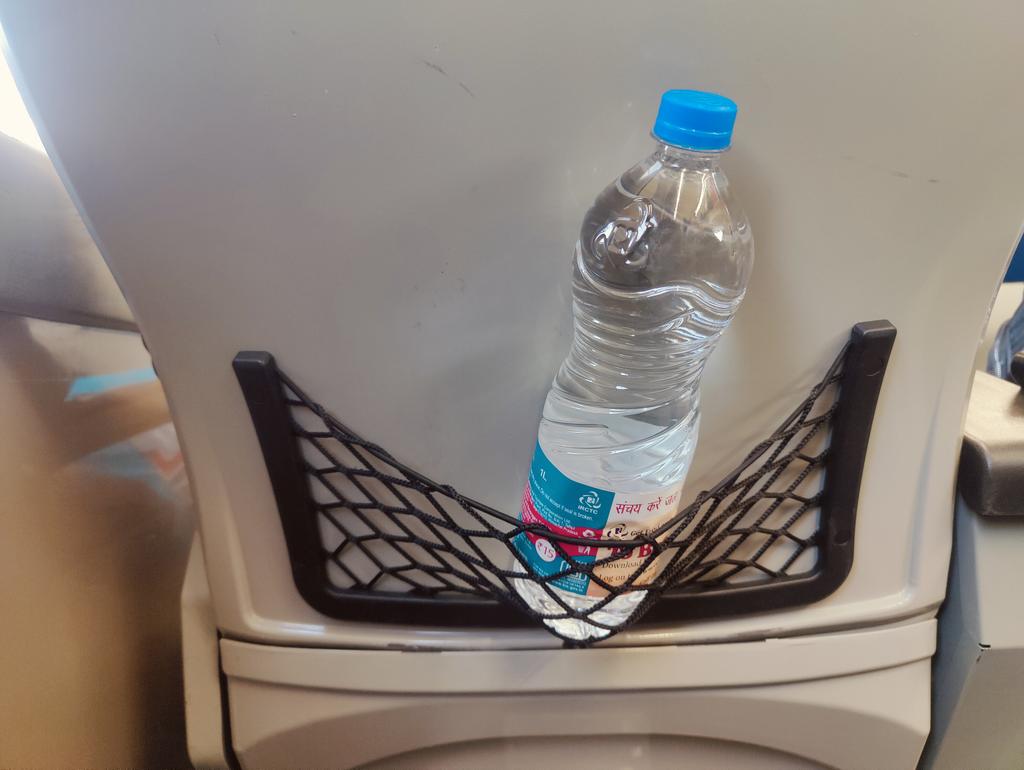 smwnair's tweet photo. @AshwiniVaishnaw sir, refer to the pic, the design (Vande Bharat express) doesn't fit the water bottle properly. A better design/idea can be looked into @RailMinIndia https://t.co/i34CN966ds