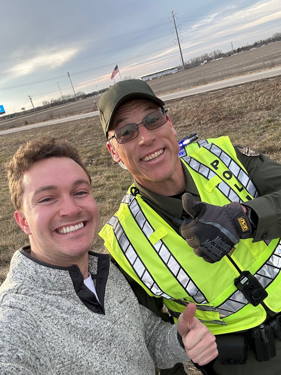 Flood4Nebraska's tweet photo. After popping a tire, a #TeamFlood member was stuck on the shoulder of I-80. Trooper Schmidt stopped to help him put on a spare. Thank you @NEStatePatrol for your service to Nebraskans when they need it most! https://t.co/busN0gFPy9