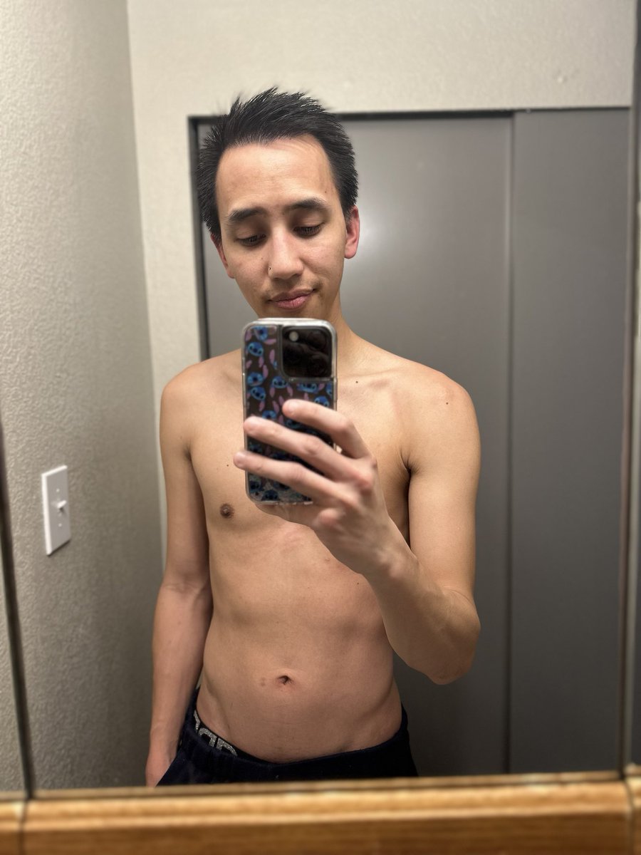 The result of working out for one week so far.

[ID: Khmer with black short hair, shirtless, taking a selfie in the hallway with a mirror.]