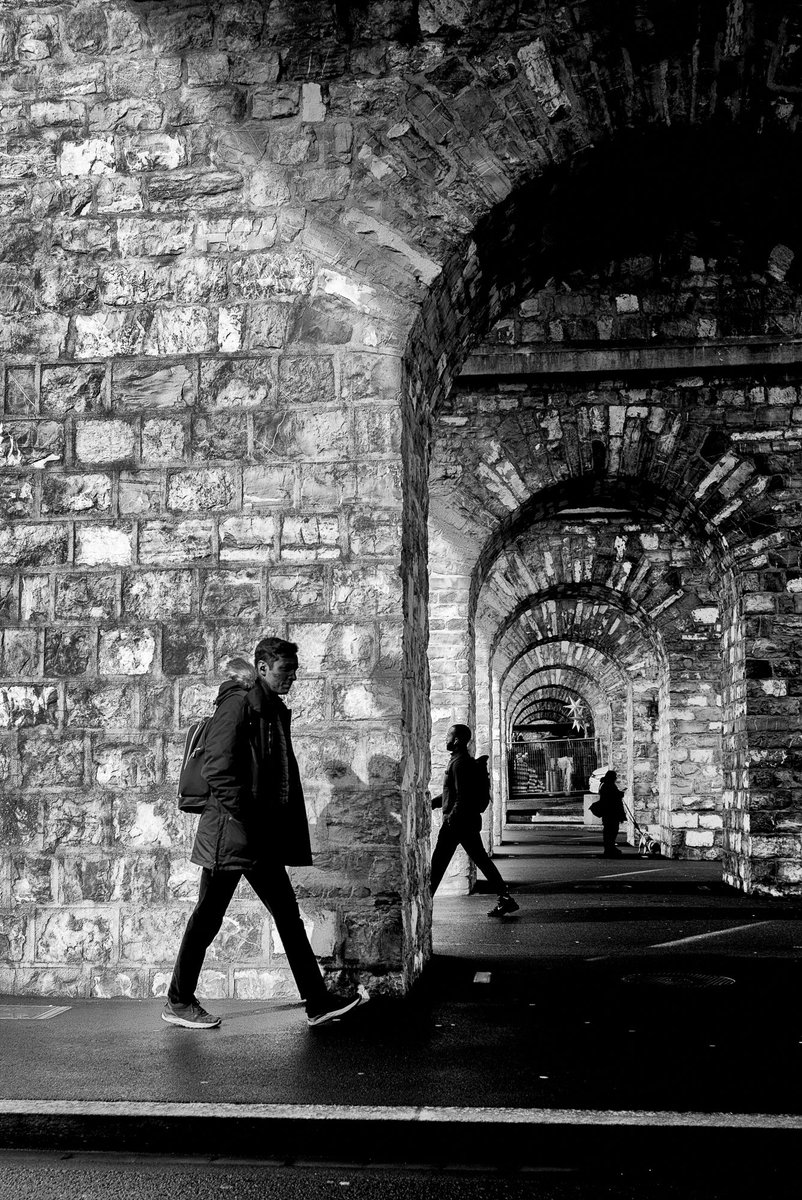 Underneath the arches in Lausanne Copyright Kieron Beard #streetphotography #bnwphotography #arches #silhouettes #leica #leicamonochrom