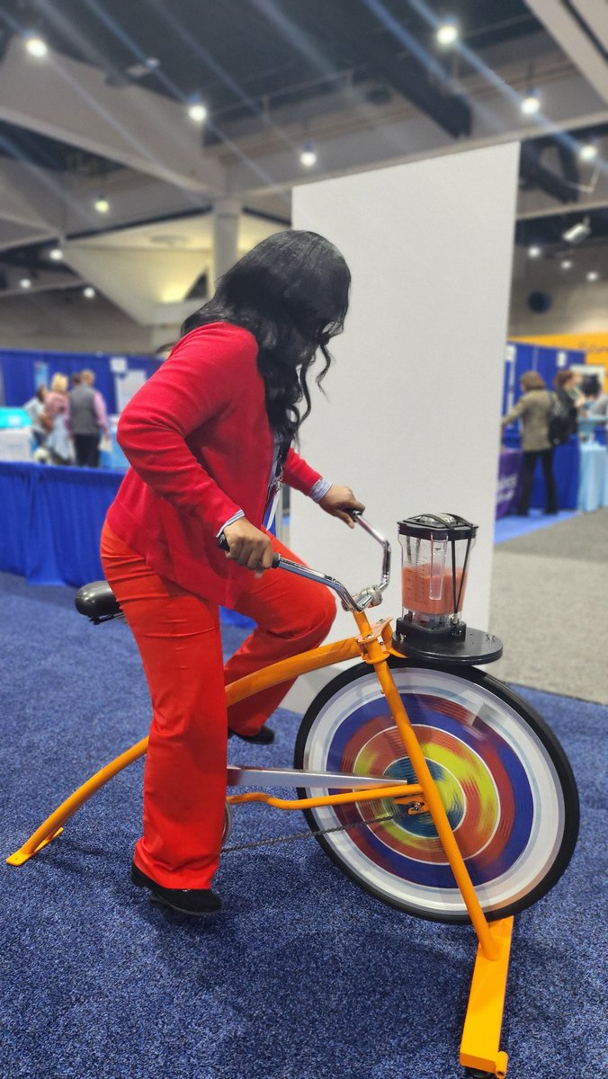 PrincipalDrH's tweet photo. Talk about #STEM !! How do you get your cardio in and make a smoothie simultaneously? With a #blenderbike ! This is the greatest creation ever! P.S....I took it back to my childhood and started to pedal, standing up! Our scholars would love this!!! #NCE2024 #Exhibithall #AASAWELL https://t.co/XmVIhpsC87