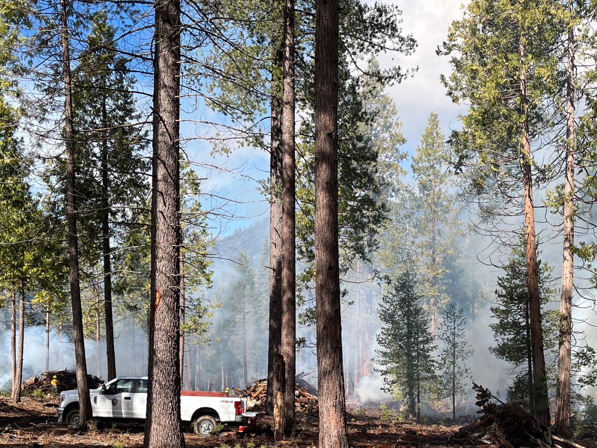 Pile burning has concluded for the week with an additional 76 piles complete. Active ignitions will resume next week, if conditions are favorable. NPS Photo/J.OCoy smoke rising from the forest with large burn piles, firefighters, and NPS truck in the area.