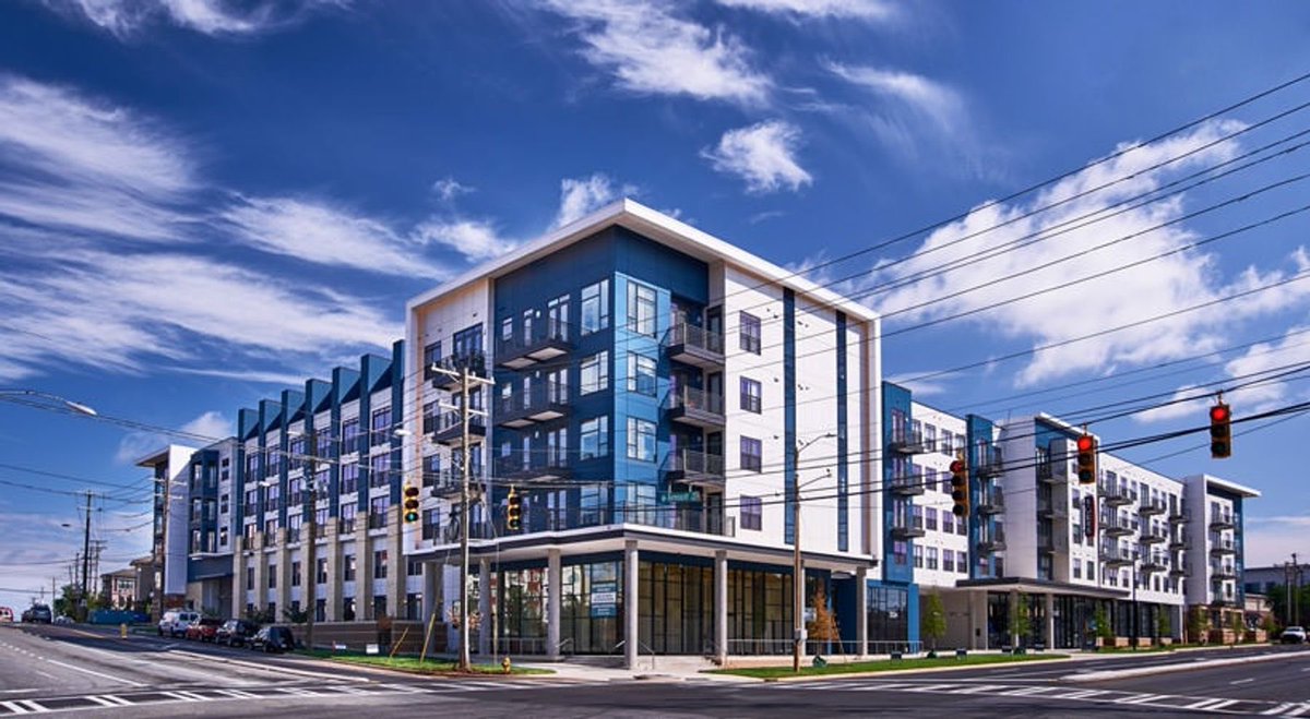 Tesho13's tweet photo. Parking lot (2015)  ➡️ 300 apartments (2022)

Two blocks from a light rail station and connected to Charlotte’s rail trail. https://t.co/c0O1ZtkvdU