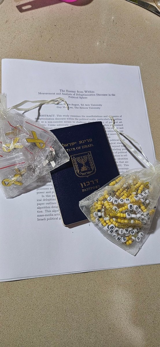 Heading to Germany tonight to present a research paper from my PhD on delegitimization of political identities. While my heart and thoughts remain with Israel, I've brought along yellow bracelets and pins to distribute among the participants. Carrying a piece of home with me.