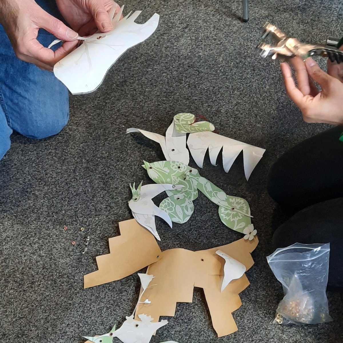 C2CArtists's tweet photo. Whilst they started out with random shapes, it soon became apparent participants wanted to create a scene and responded to each other's ideas. Foliage, waves, fish and a bird emerged to create a dream-like scene. We joined them together using a combination of eyelets and thread. https://t.co/S2qjaVoUnN