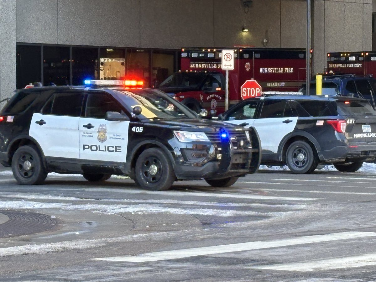 A solemn sight as officers from all over metro surround a Burnsville paramedic vehicle.  Dozens of officers paying respect in downtown Minneapolis at HCMC.  #wcco