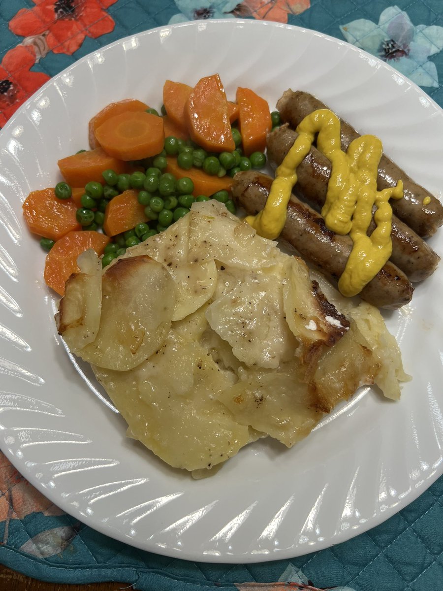 Comfort food on another stormy day. Scalloped potatoes with sausages and buttered peas and carrots.