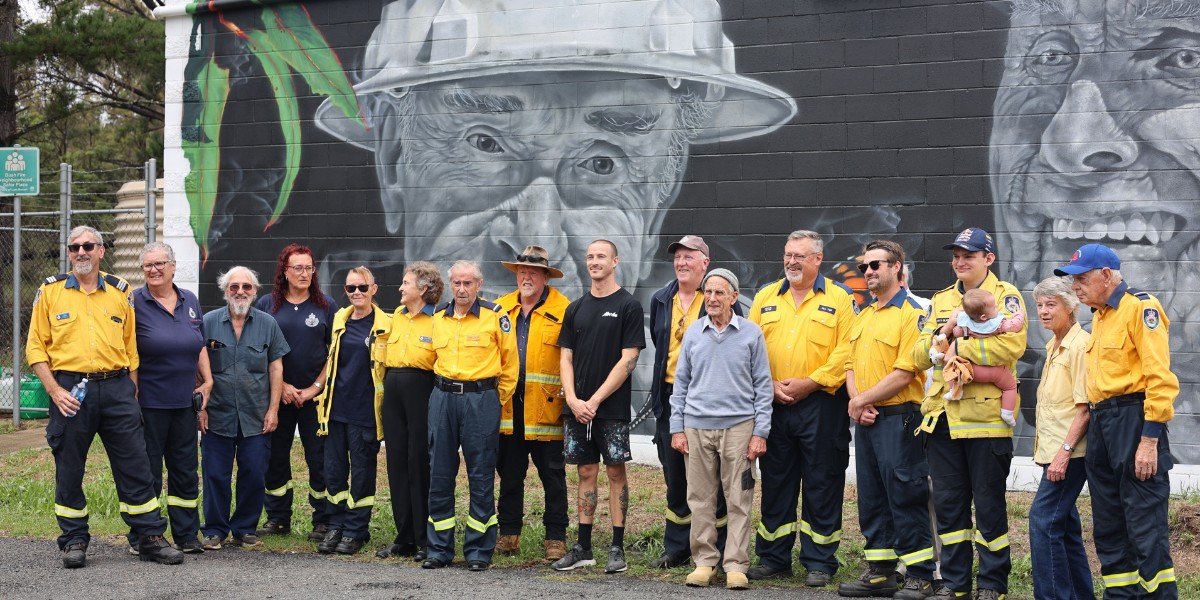 NSWRFS's tweet photo. The Hill Top Brigade unveiled a special mural on Friday. Spread across an entire wall of Hill Top station, the painting features long-serving volunteers Brian Coates and John Matters. Between the two of them, Brian and John have dedicated some 150 years to the RFS. https://t.co/tto5fQeyzH