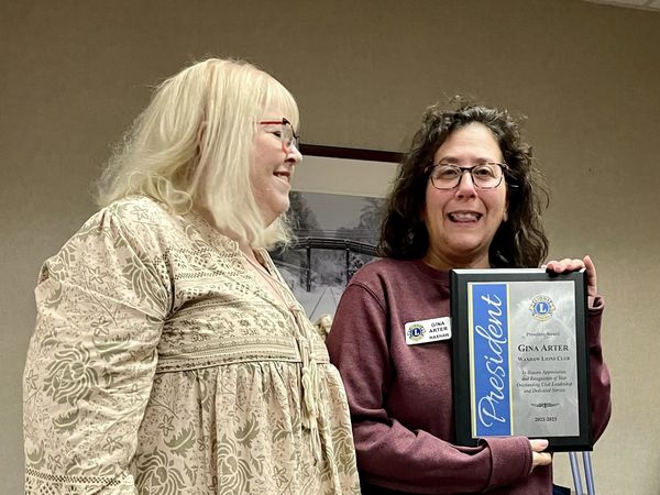 Waxhaw Lions Club President Joy Koziol presented a plaque to Gina Arter, immediate past president, for  outstanding club leadership in 2022-23. Under her leadership, the club won  the International Lions Club Excellence Award &amp; Lions District 31-O’s 100% Club Award. (WLC photo)