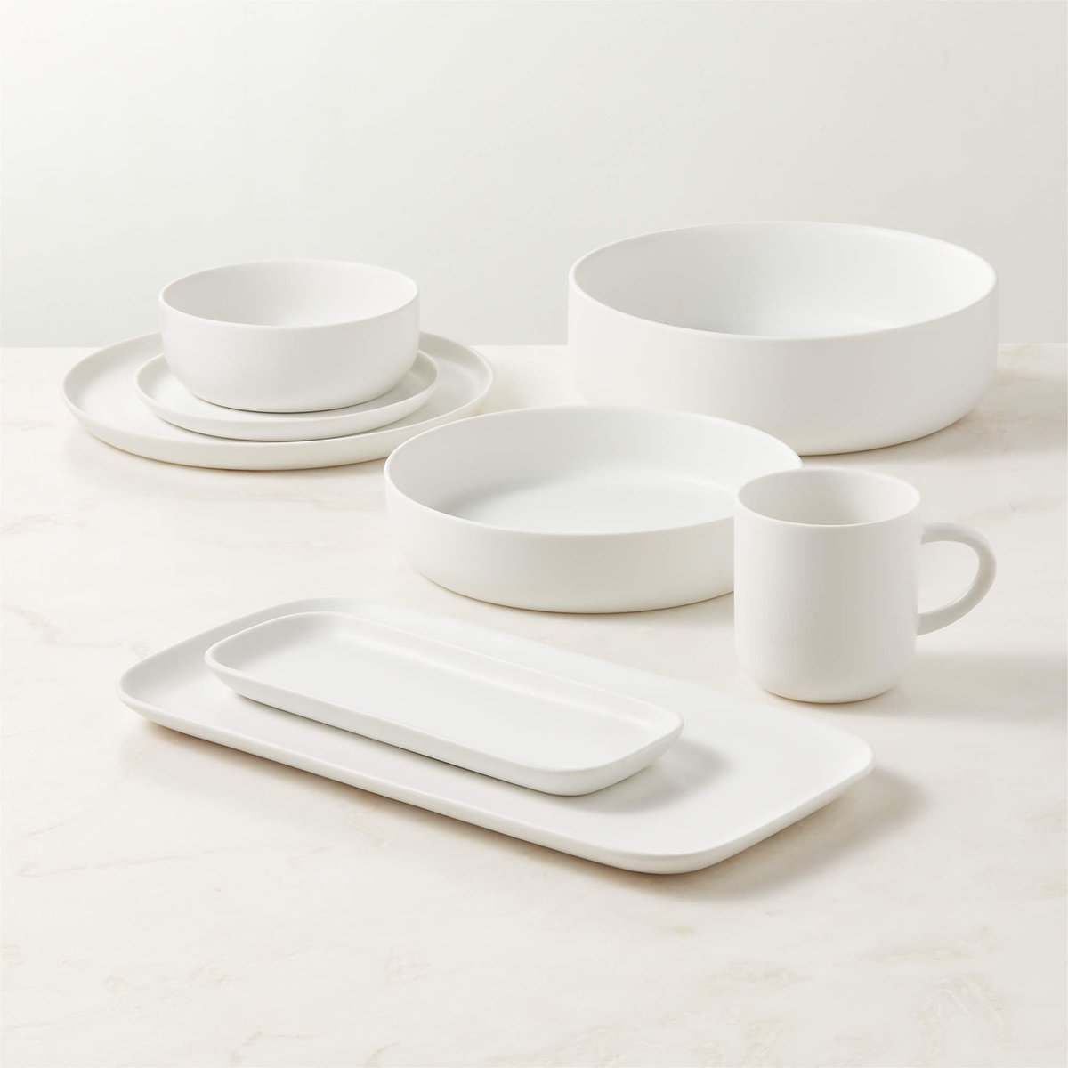 usgraphics's tweet photo. Dinner/Drinkware design has several features that go unnoticed, but are glaringly obvious when they are missing. 🧵(1/2)

Take for e.g. these modern dinnerware sets. They are everywhere. What's the problem with these?

1) Flat plates struggle to contain foods with gravy/sauce, causing messes with the slightest movement. 

2) The absense of bottom rim means dirt from countertops can easily transfer to the flat bottom. A tiny drop of sauce smears across a large flat bottom. And you'll be stamping that dab of sauce everywhere with your plate. This escalates fast as other plates then pick up the sauce.

3) Lack of a thumb rest around the edge of the plate complicates handling. Handle it from the top rim and you've just created a fulcrum at the edge of the plate (Unstable). Your thumb will most likely land inside the serving area as you struggle, overrun by sauces sloshing around on a flat surface.

4) Handling is further undermined as you try to pick up the plates. There is no overhang for your fingers to slide under.