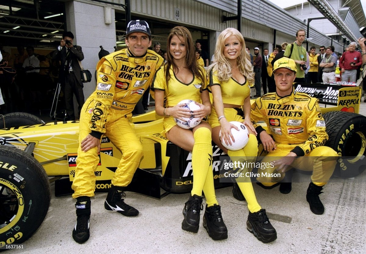 Jordan-Mugen Honda drivers Damon Hill of Great Britain and Ralf Schumacher of Germany pose for the camera with Melinda Messenger and Jordan before the British Grand Prix at the Silverstone circuit in Northampton, England. (1998)