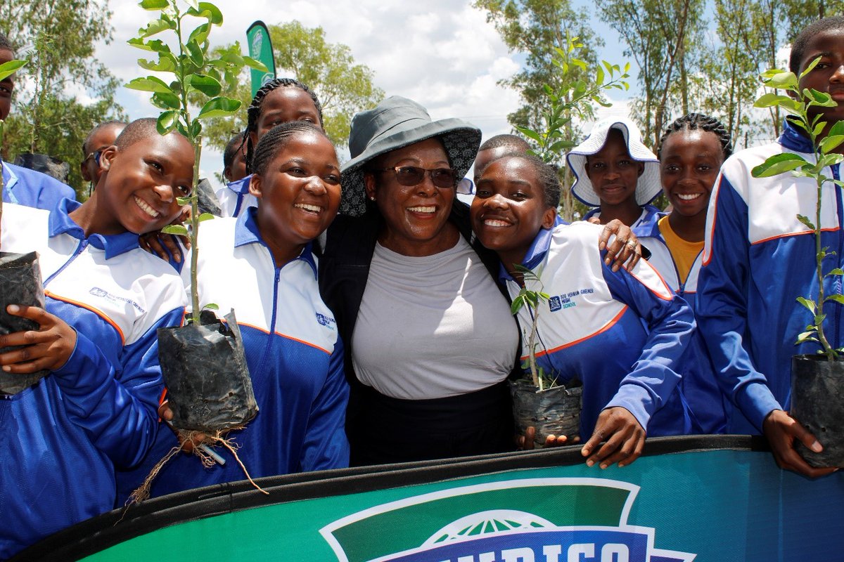 ‘Planting Smiles, Planting Trees: Dr. Divine Simbi Ndhlukula and the radiant students of SOS Bindura, embrace a moment of triumph after a successful tree planting event held by SECURICO in partnership with Forestry Commission. They sow the seeds of a brighter and greener future.