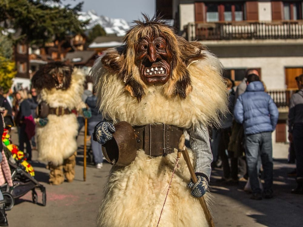 Duossoles's tweet photo. A Lötschental Valley resident dressed as a Tschägättä strolls around the village of Wiler, in Valais, Switzerland moments before the annual Carnival Parade begins. https://t.co/8pktyzZgr5