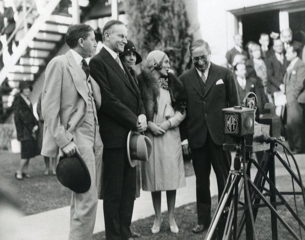 President Calvin Coolidge looks on as Mary shares a joke with Louis B. Mayer while on a tour of MGM Studios in 1930. #marypickford #calvincoolidge #presidentsday #mgmstudios