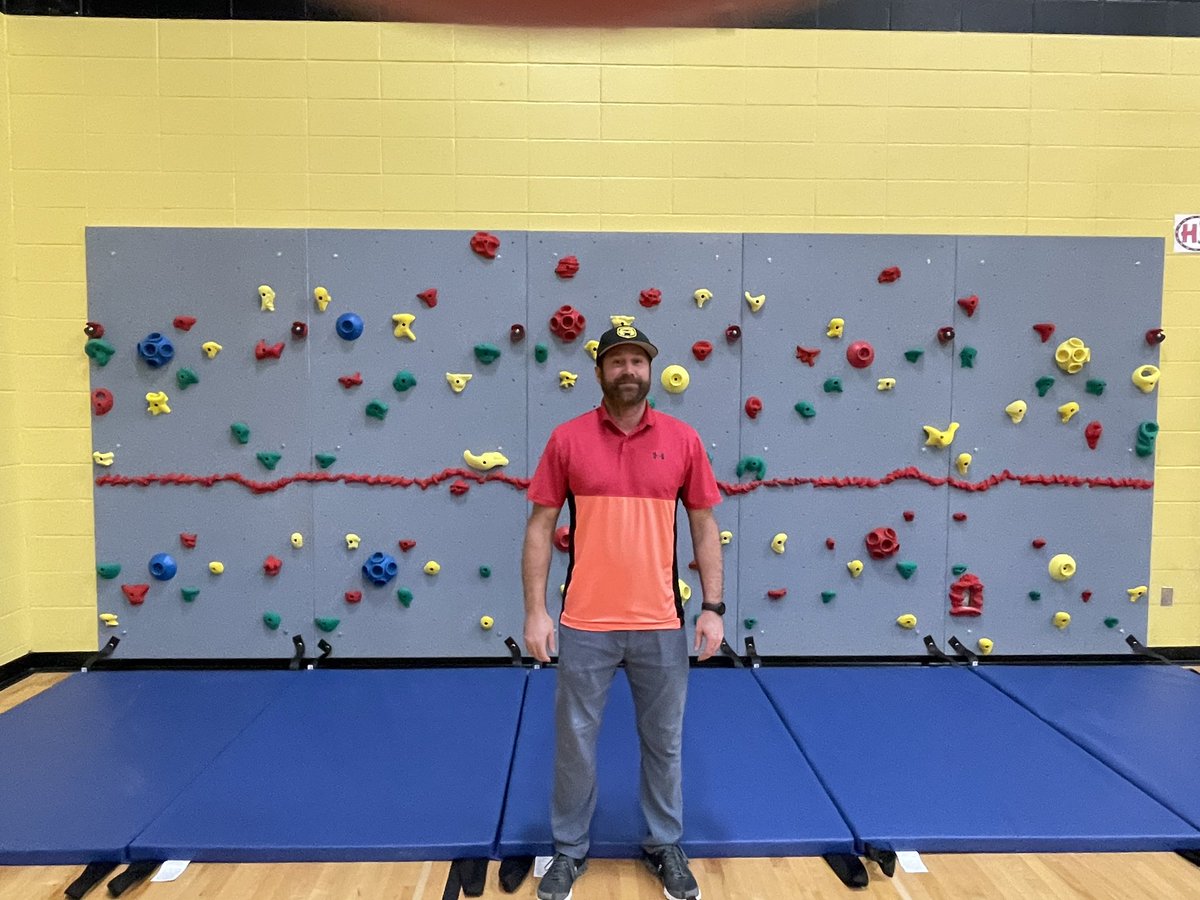 aberodemeyer's tweet photo. Check out our physical education teacher, Mr. Rizzo, standing in front of our new BIS climbing wall! So excited for our kids! This was made possible with all the community support and donations through the Color Run and Boosterthon! #bisstars, #byronbears https://t.co/Ym6MtoInaj