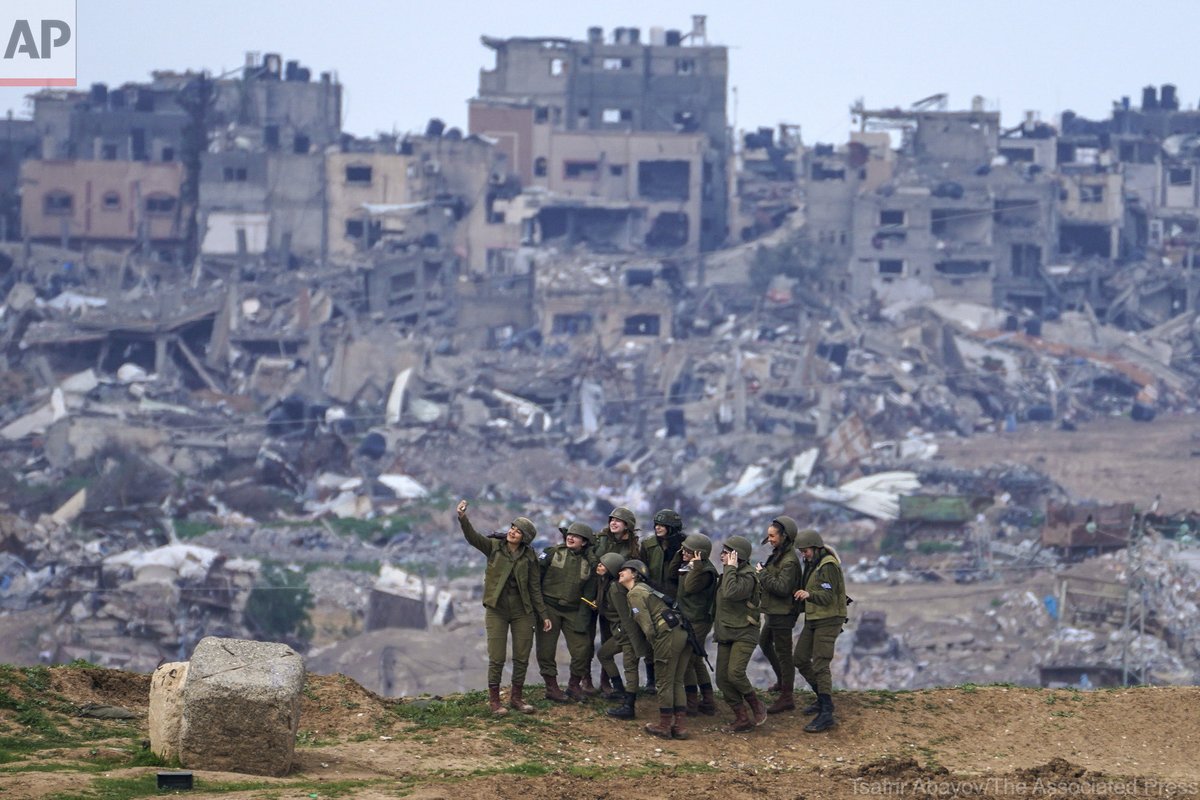 This photo…. Israeli female soldiers pose for a photo on a position on the Gaza Strip border, in southern Israel, Monday, Feb. 19, 2024. (AP Photo/Tsafrir Abayov)