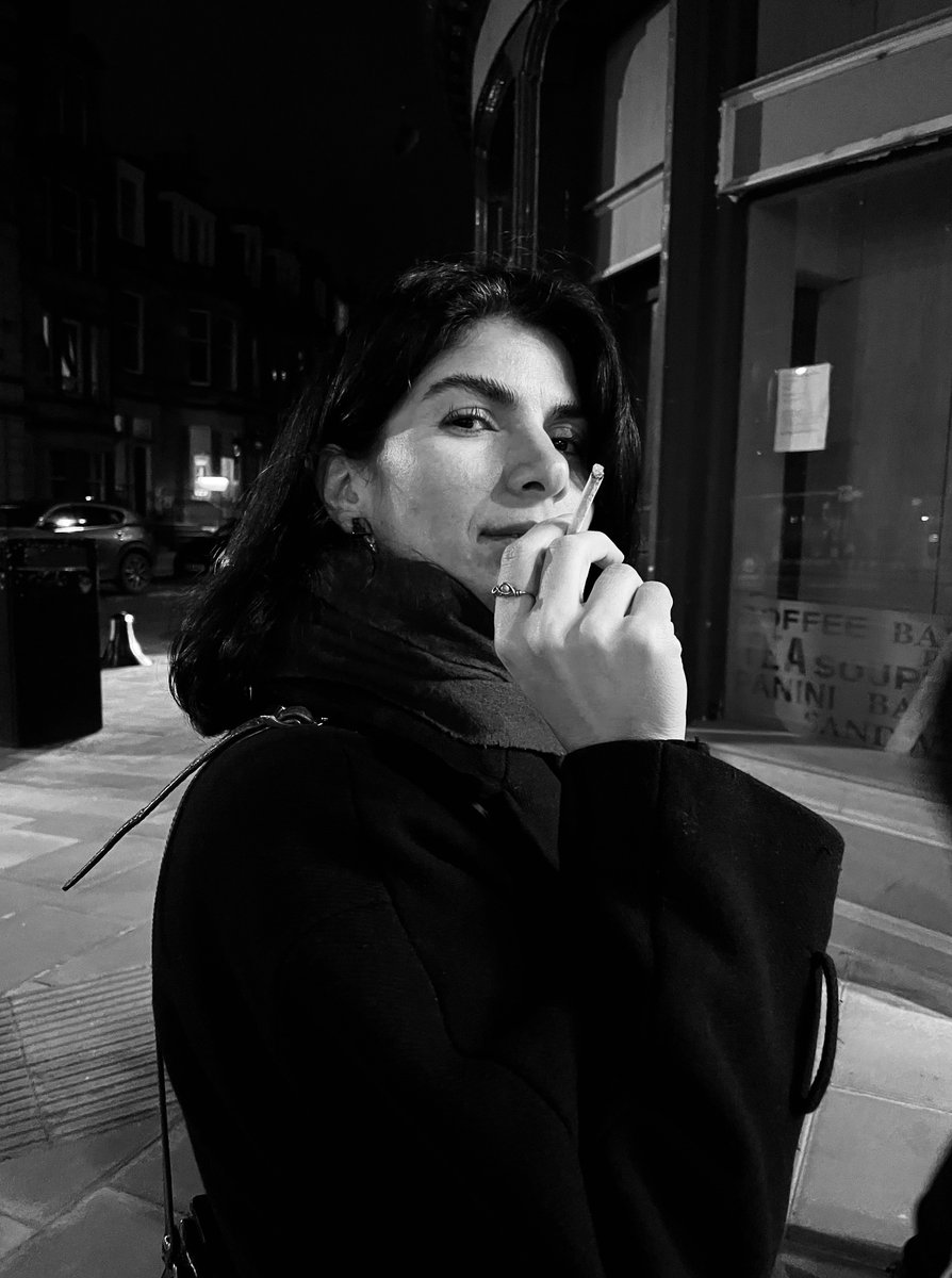 An exiled Kurdish lady is smoking. Edinburgh, 2024 (black and white)