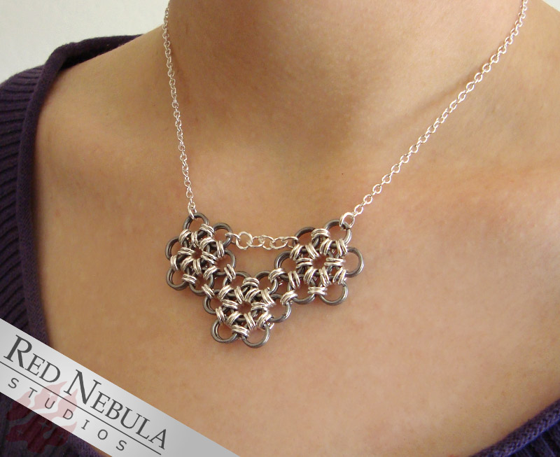 This is a chainmail necklace I made, it's a three flower design made with silver-plated brass rings. - Robbie.