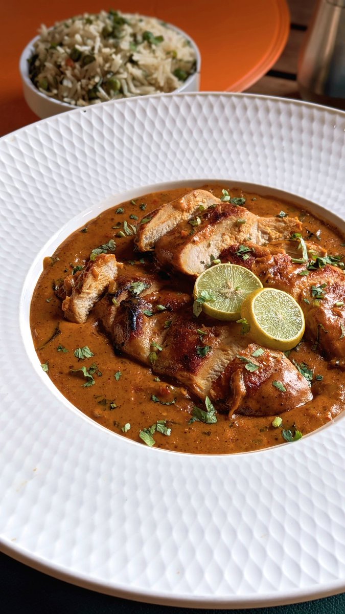 Brazilian coconut chicken stew with green cilantro and pea rice.
