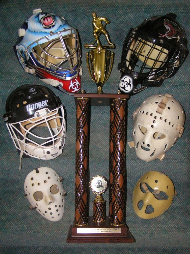 IcedocSmith's tweet photo. @KevinWeekes Masks I've worn since the 70s, upper left is my current one. Plastic one is a WinnWell. Jacques Plante Fibrosport at lower left, and that's a genuine Ernie Higgins that he made for me circa 1976 https://t.co/03z35D6SCh