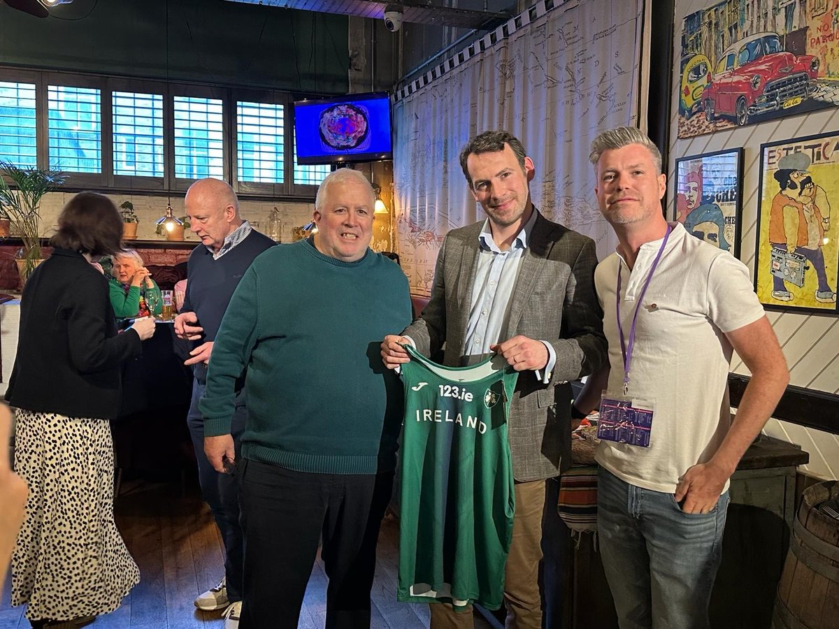 Irish Consul General to Scotland is presented with an Irish vest by the Athletics Ireland President and Séamus Carey at the Athletics Ireland Supports Club Event in Glasgow during the World Indoor Track Championships.